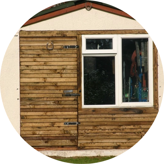 Repaired timber shed with new cladding and window