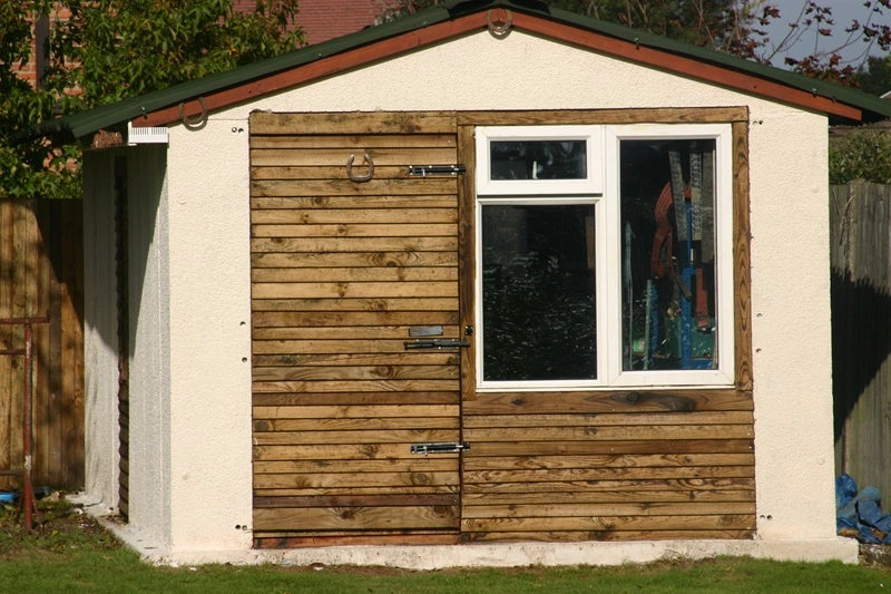 Rendered garden shed with new timber door and window